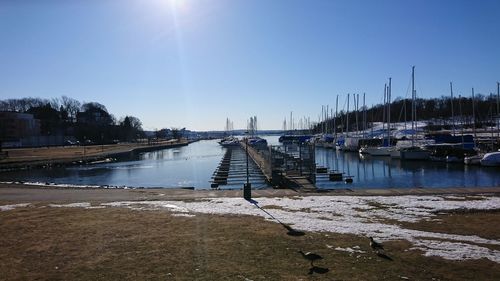 Sailboats in marina against sky