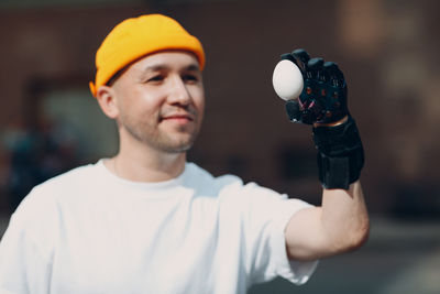 Portrait of young man holding camera