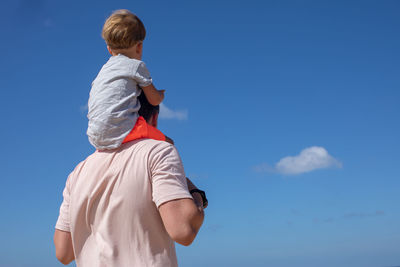 Father and son having fun on sky