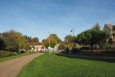 Park by street against sky