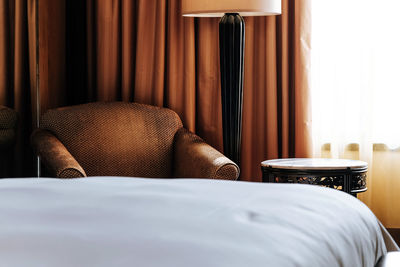 Midsection of man relaxing on bed at home