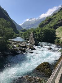 Scenic view of waterfall against sky