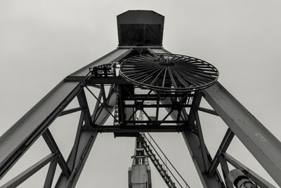 Low angle view of ferris wheel against sky