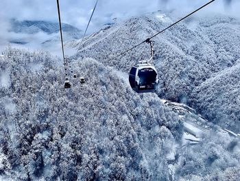 Overhead cable car covered with snow