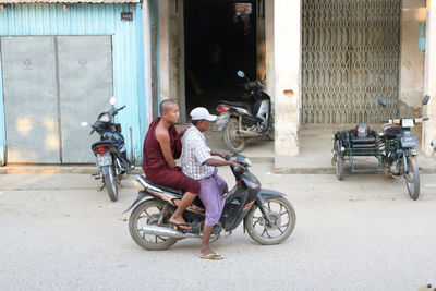 Man sitting on motor scooter