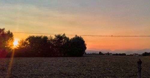 Scenic view of landscape against sky at sunset