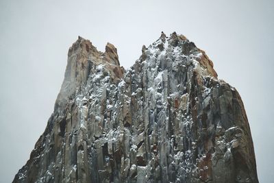 Low angle view of rock formation against sky