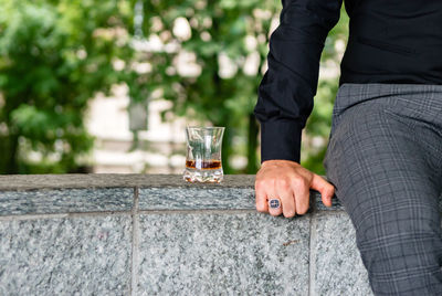Midsection of man holding drink