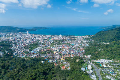 High angle view of townscape by sea against sky