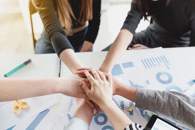 High angle view of people hands on table