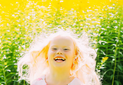 Portrait of happy little girl outdoors