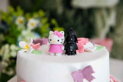 Close-up of cake with pink flowers on table