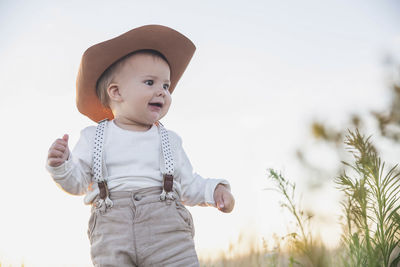 Portrait of cute girl standing on field