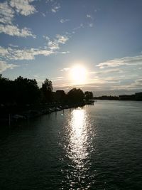 Scenic view of river against sky at sunset