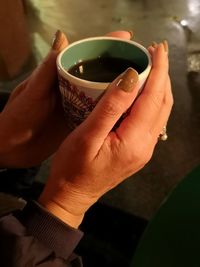 Close-up of hand holding drinking glass