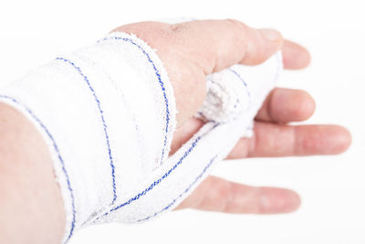 Close-up of man hand over white background