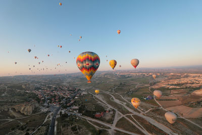 Hot air balloon flying over city