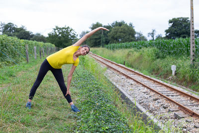 Full length of woman standing on railroad track