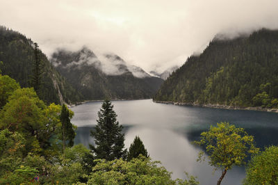 Scenic view of calm lake against mountain range