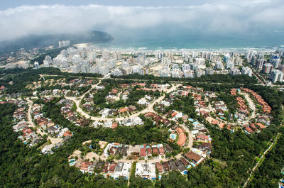 High angle view of buildings and sea against sky