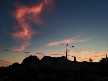 Low angle view of silhouette buildings against sky at sunset