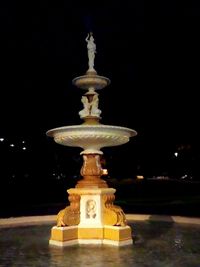 Close-up of fountain against illuminated light at night