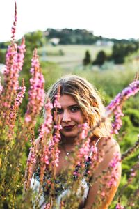 Portrait of a smiling young woman on flowering plants