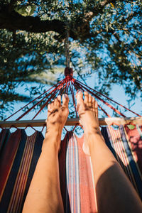 Low angle view of woman standing on hammock