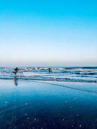 Scenic view of sea against clear blue sky