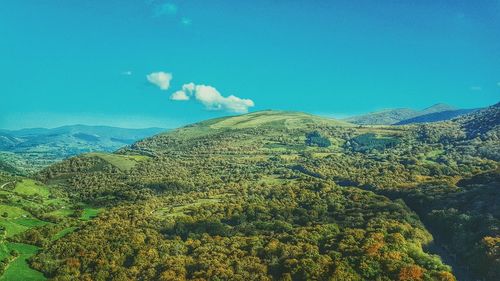 Scenic view of mountains against blue sky