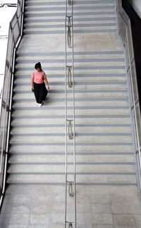 High angle view of woman moving down on staircase