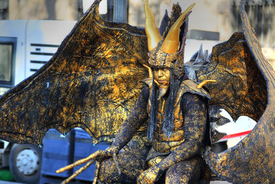 Close-up of statue against tree trunk