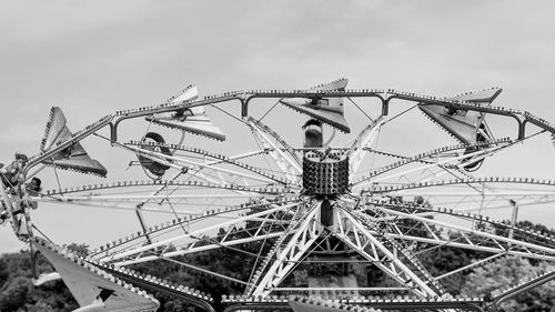 Low angle view of fairground ride against sky.