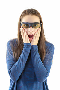 Portrait of surprised girl wearing 3-d glasses against white background