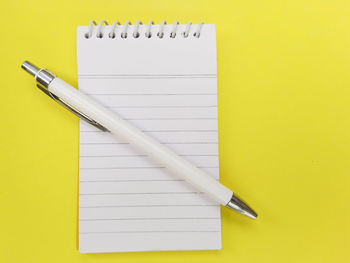 High angle view of pen on yellow table