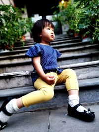 Boy sitting on staircase
