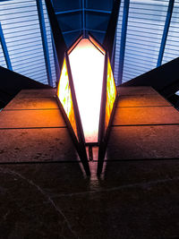 Illuminated lights on building wall at night