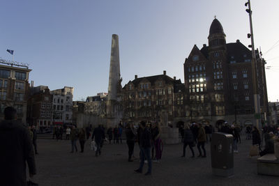 Group of people in front of buildings in city