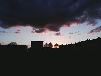 Silhouette buildings against sky during sunset