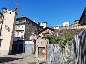 Low angle view of old building against clear blue sky