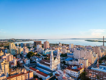 High angle view of buildings against blue sky