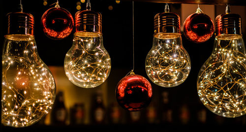 Close-up of illuminated lamp hanging on table