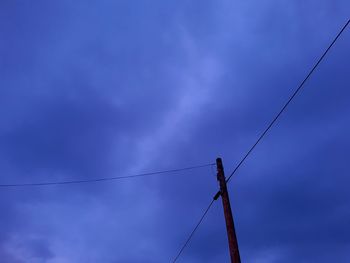 Low angle view of electricity pylon against sky