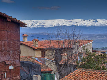 Houses against sky during winter