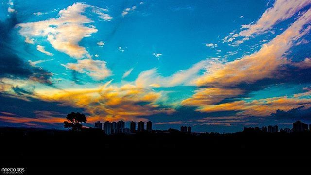 sunset, silhouette, sky, scenics, beauty in nature, cloud - sky, tranquil scene, tranquility, blue, nature, orange color, cloud, idyllic, landscape, building exterior, tree, dramatic sky, built structure, dusk, outdoors