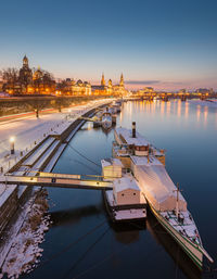 High angle view of illuminated city at riverbank