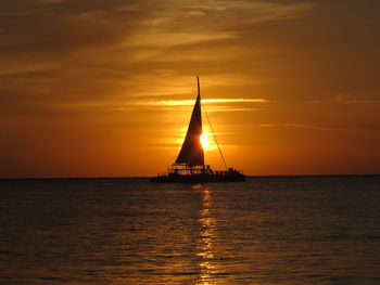 Sailboat on sea at sunset