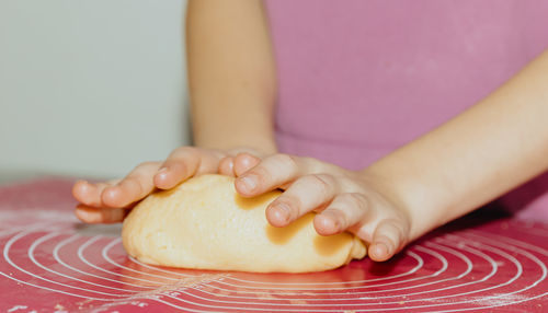 Midsection of woman holding food on table