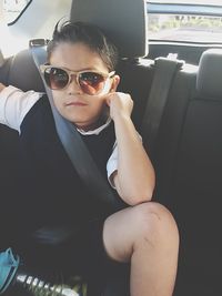 Young man sitting in car
