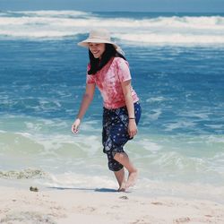 Full length of woman on beach against sky